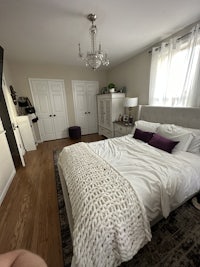 a small bedroom with a bed and a dresser