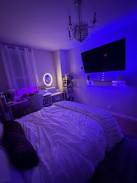a bed in a room with blue lights on it